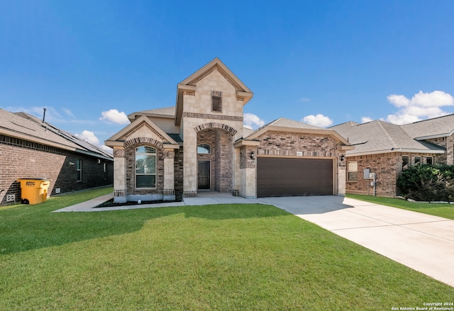 view of front of home featuring a front yard and a garage