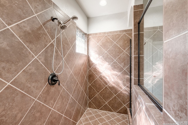 bathroom with tiled shower