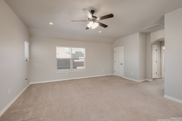 carpeted empty room featuring ceiling fan and vaulted ceiling