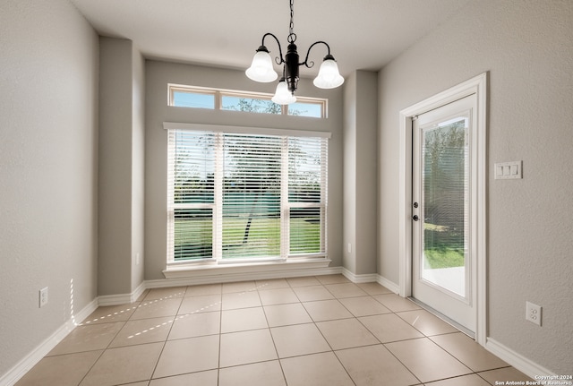 entryway featuring light tile patterned floors and an inviting chandelier