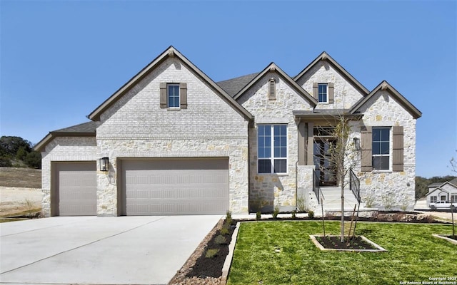 334 Dulce Vis, Boerne, TX 78006 - french country style house with a front lawn, concrete driveway, stone siding, and an attached garage