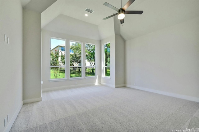 carpeted spare room with ceiling fan and lofted ceiling