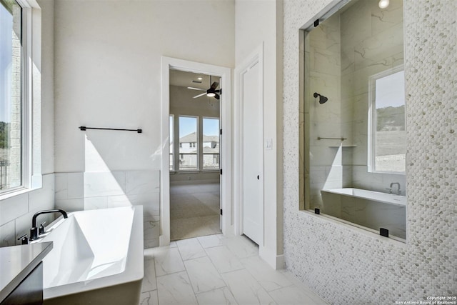 334 Dulce Vis, Boerne, TX 78006 - full bath featuring a freestanding bath, marble look tile flooring, tiled shower, and a ceiling fan