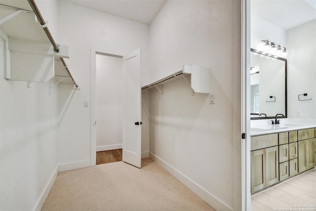 334 Dulce Vis, Boerne, TX 78006 - walk in closet with light colored carpet and a sink