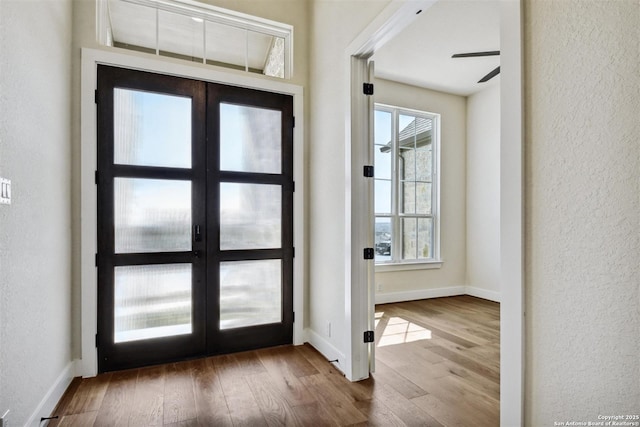 334 Dulce Vis, Boerne, TX 78006 - entryway featuring wood finished floors, a textured wall, plenty of natural light, french doors, and baseboards