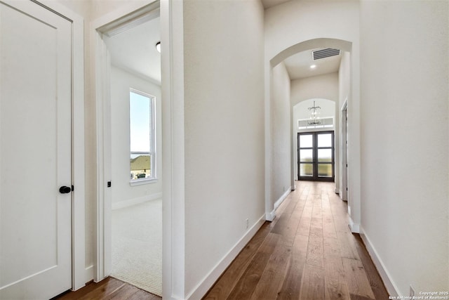 334 Dulce Vis, Boerne, TX 78006 - corridor with arched walkways, plenty of natural light, hardwood / wood-style flooring, and a chandelier