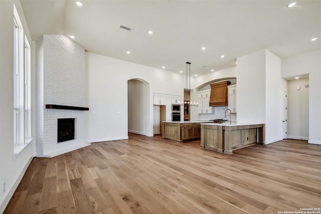 334 Dulce Vis, Boerne, TX 78006 - kitchen featuring light countertops, open floor plan, a sink, light wood-type flooring, and recessed lighting