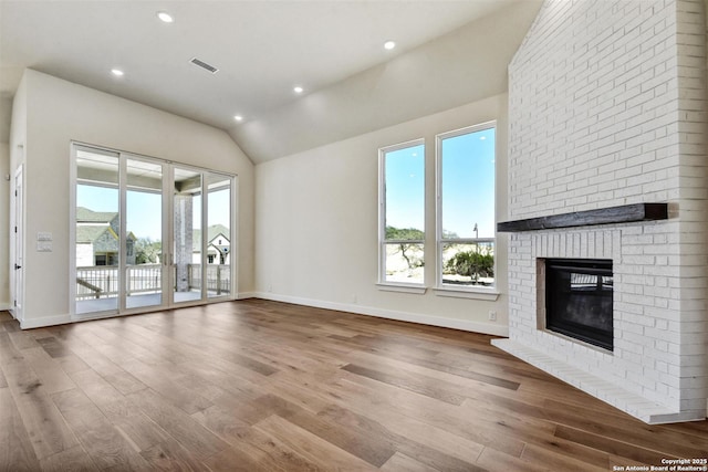 334 Dulce Vis, Boerne, TX 78006 - unfurnished living room with plenty of natural light, lofted ceiling, wood finished floors, a fireplace, and baseboards