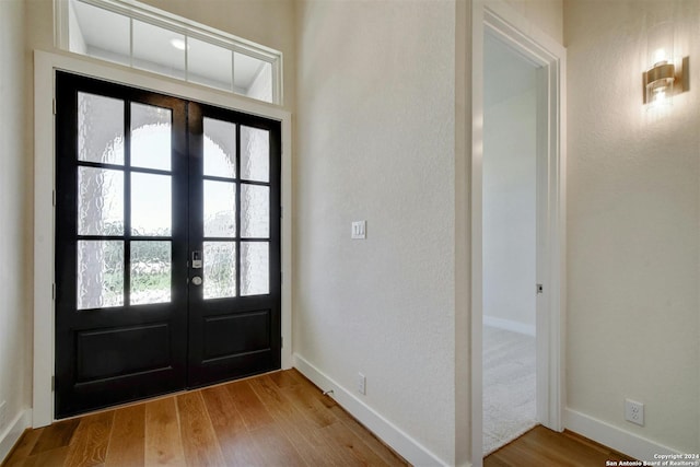 entryway featuring wood-type flooring and french doors