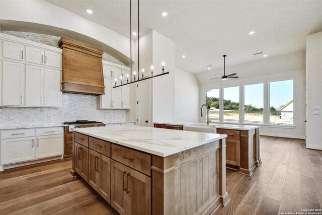 334 Dulce Vis, Boerne, TX 78006 - kitchen featuring a center island, a ceiling fan, custom range hood, wood finished floors, and lofted ceiling