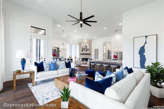 living room with ceiling fan, hardwood / wood-style floors, and a fireplace