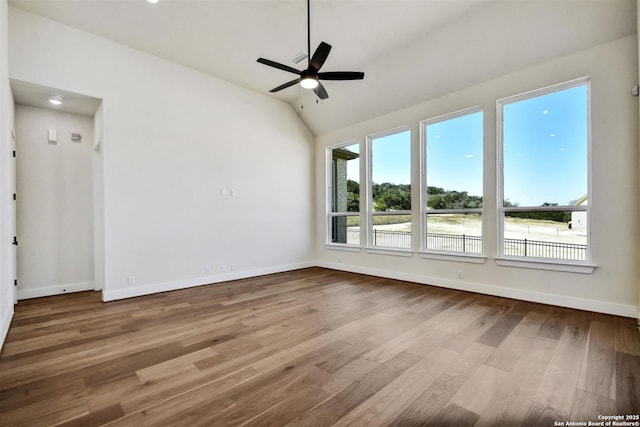 334 Dulce Vis, Boerne, TX 78006 - spare room featuring baseboards, wood finished floors, ceiling fan, and vaulted ceiling