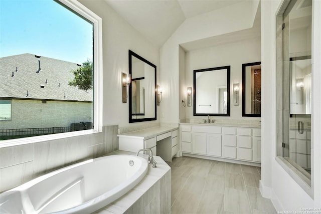 bathroom with vaulted ceiling, plus walk in shower, and vanity