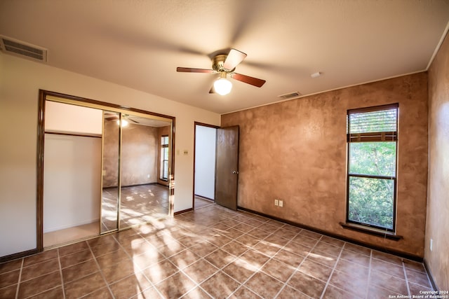 unfurnished bedroom with a closet and ceiling fan