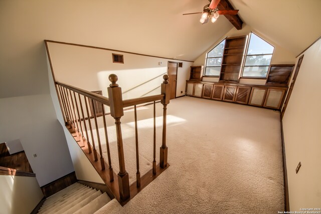 bonus room featuring vaulted ceiling with beams, light colored carpet, and ceiling fan