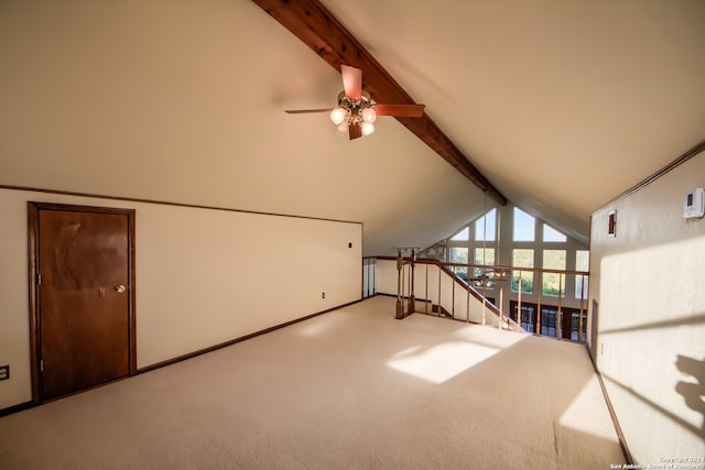 unfurnished living room featuring beam ceiling, ceiling fan, carpet floors, and high vaulted ceiling