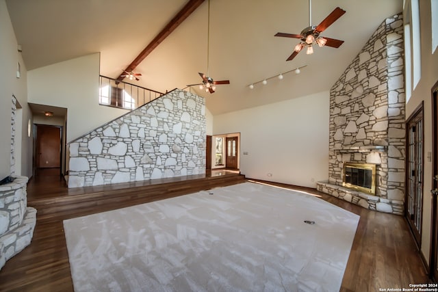 unfurnished living room featuring ceiling fan, dark hardwood / wood-style flooring, and high vaulted ceiling