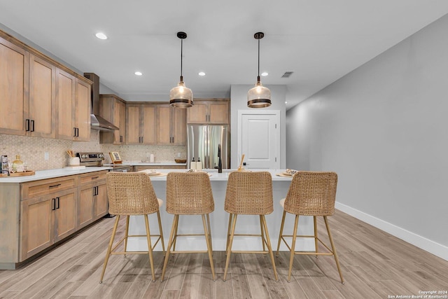 540 River Run Unit 114, New Braunfels, TX 78132 - kitchen with appliances with stainless steel finishes, wall chimney range hood, baseboards, decorative backsplash, and light countertops