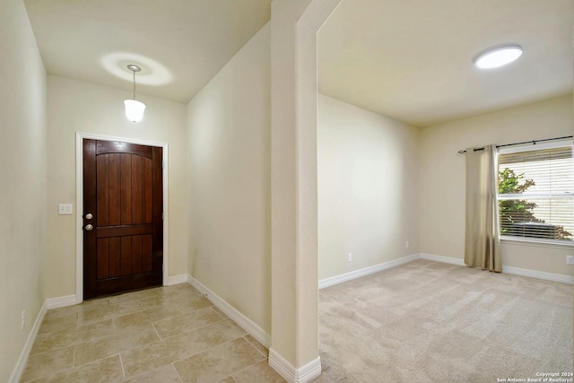 view of carpeted entrance foyer