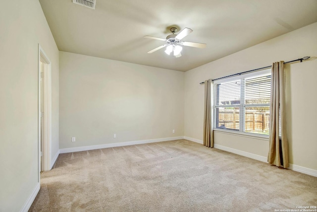 unfurnished room featuring ceiling fan and light carpet