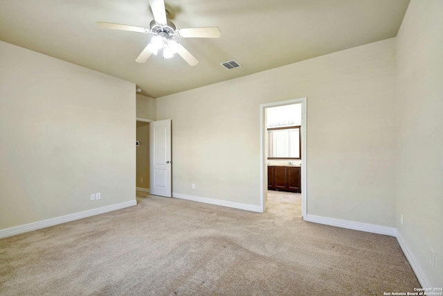 empty room with ceiling fan and light colored carpet