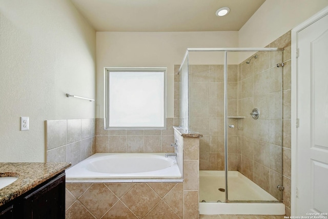 bathroom featuring vanity and shower with separate bathtub