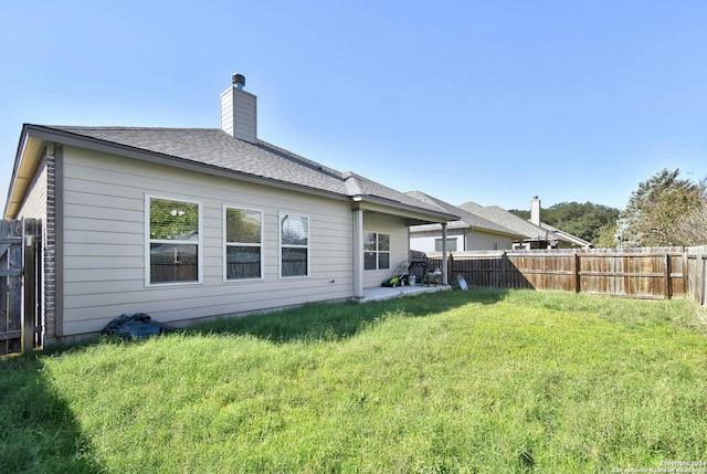 back of house featuring a lawn