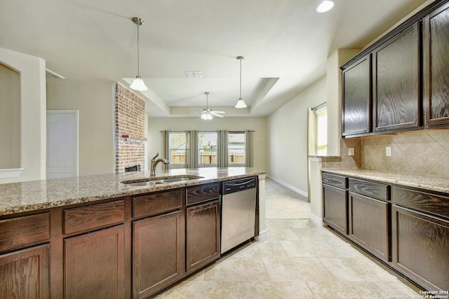 kitchen featuring light stone countertops, dark brown cabinets, sink, dishwasher, and hanging light fixtures