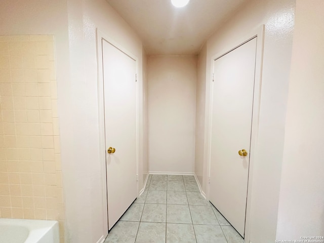 corridor featuring light tile patterned floors