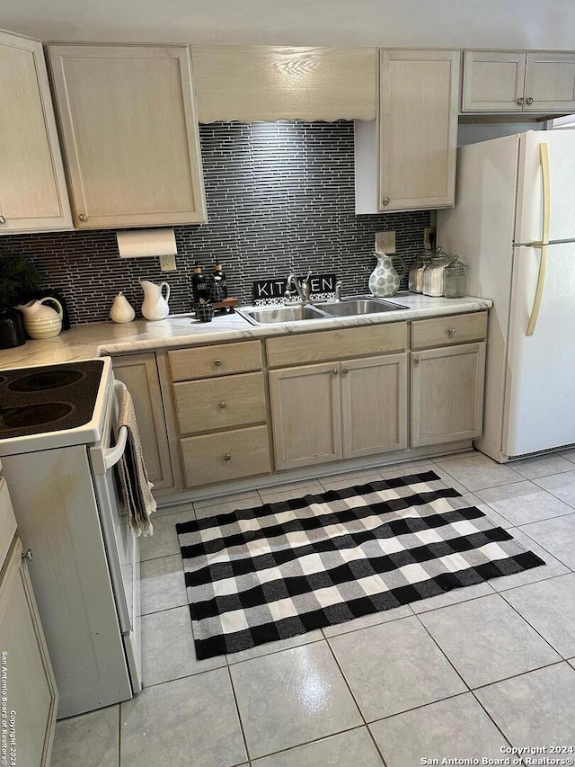 kitchen featuring white appliances, sink, light tile patterned floors, and tasteful backsplash