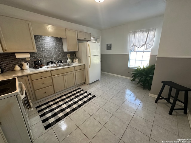 kitchen with white appliances, backsplash, sink, light tile patterned floors, and light brown cabinetry