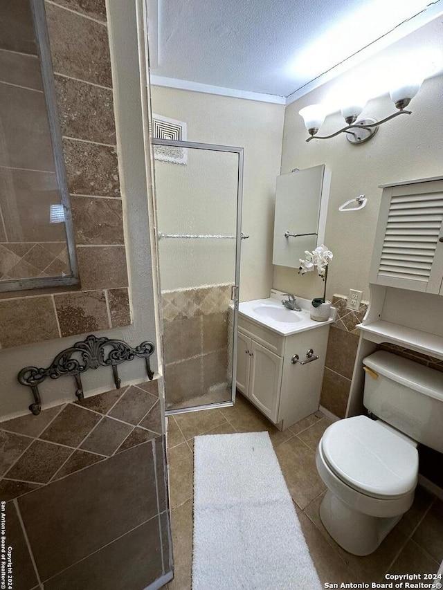 bathroom with tile patterned flooring, a textured ceiling, vanity, and toilet