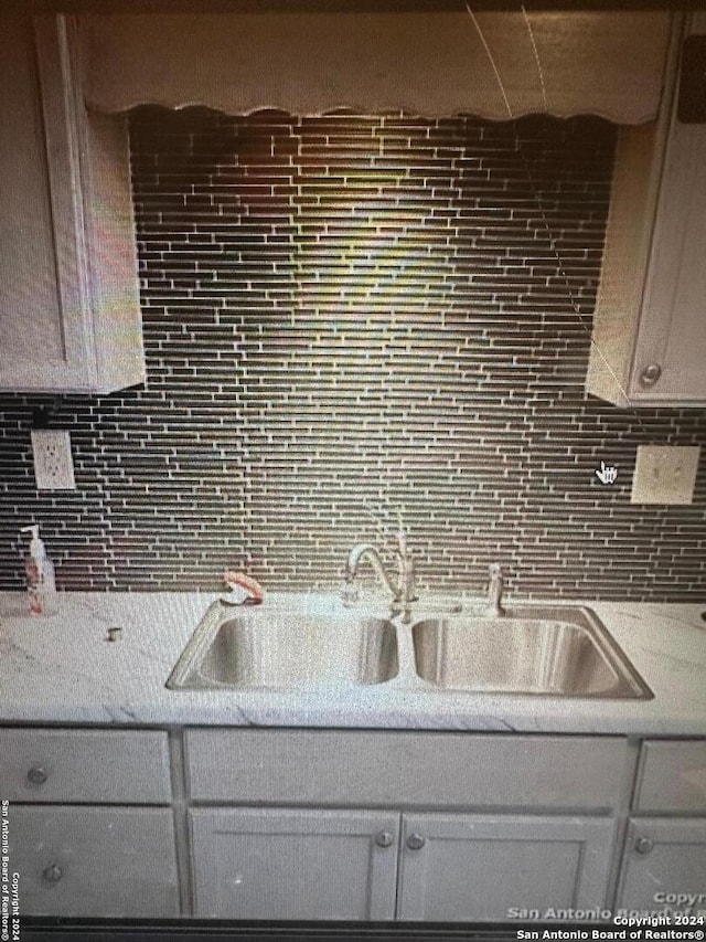 kitchen featuring sink and tasteful backsplash