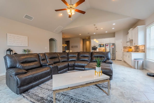 living room featuring ceiling fan and high vaulted ceiling