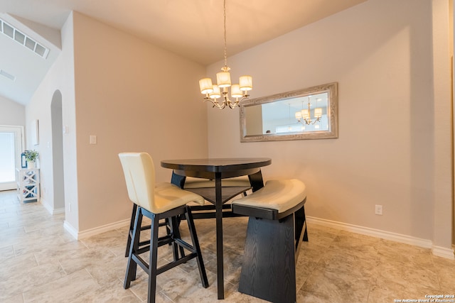 dining space featuring vaulted ceiling and an inviting chandelier