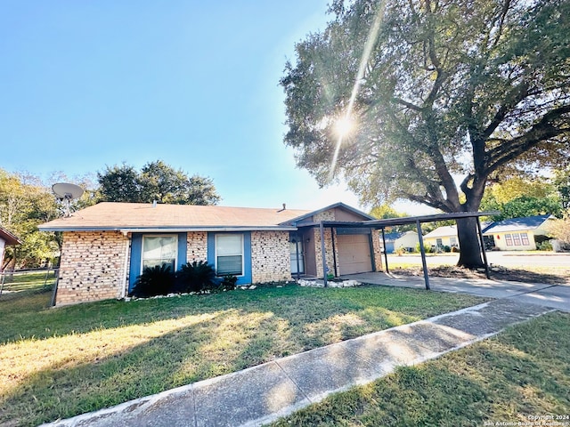 ranch-style house with a front lawn, a garage, and a carport