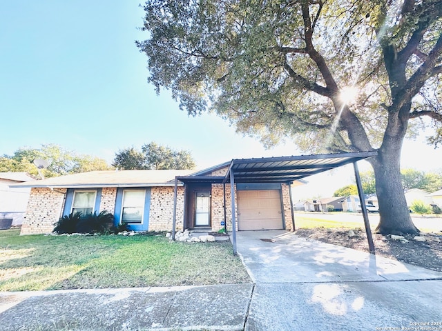 view of front of property with a carport, a garage, and a front yard