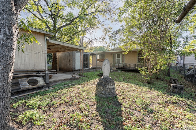 view of yard with a storage shed and a wooden deck