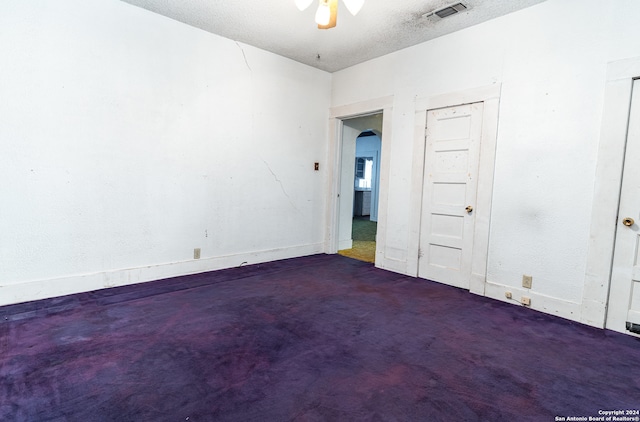 spare room featuring ceiling fan and a textured ceiling