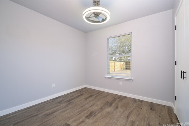 unfurnished room featuring dark hardwood / wood-style floors and ceiling fan