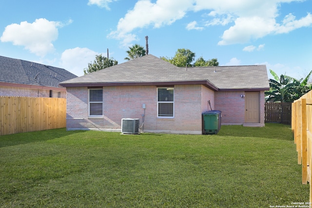 back of property featuring a yard