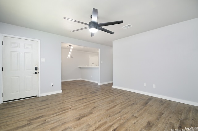 unfurnished living room with ceiling fan and hardwood / wood-style floors