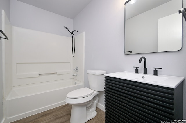 full bathroom featuring toilet, vanity,  shower combination, and hardwood / wood-style flooring