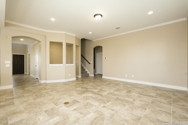 unfurnished room with crown molding