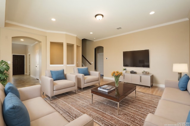 living room featuring crown molding and light hardwood / wood-style floors