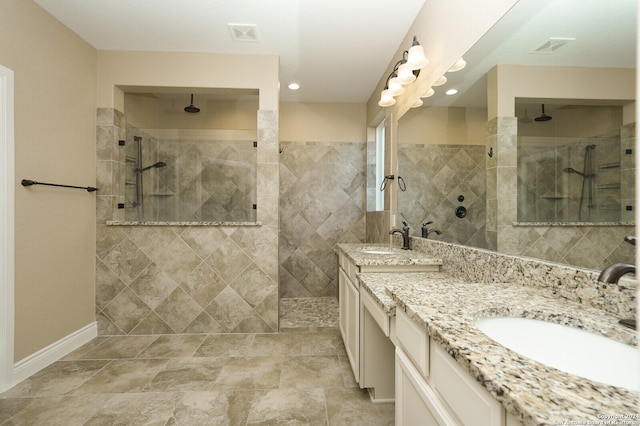 bathroom with vanity and tiled shower