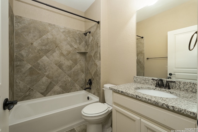 full bathroom with tile patterned floors, vanity, toilet, and tiled shower / bath combo