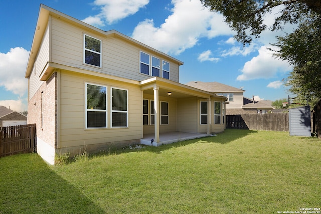 back of house with a lawn and a patio area