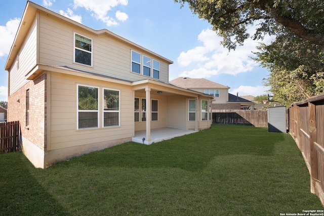 back of property with a yard and a patio