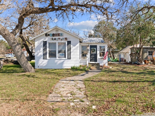 bungalow-style home with a front lawn